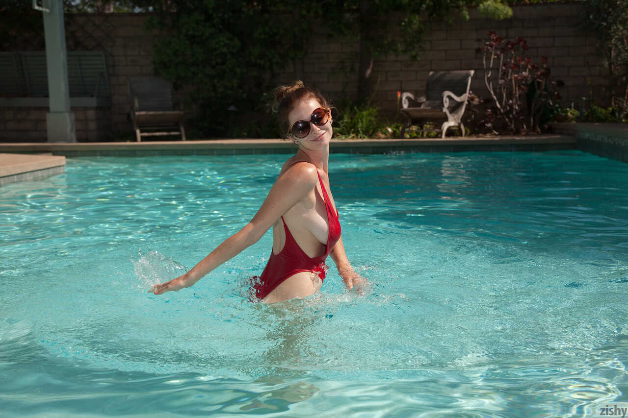 Amateur teen Essie Halladay's big round tits bob up and down in the swimming pool - Essie Halladay