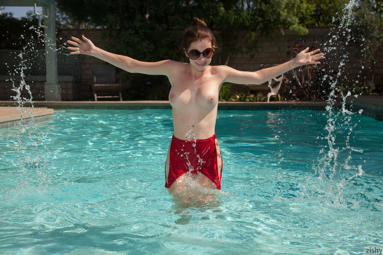 Amateur teen Essie Halladay's big round tits bob up and down in the swimming pool - Essie Halladay