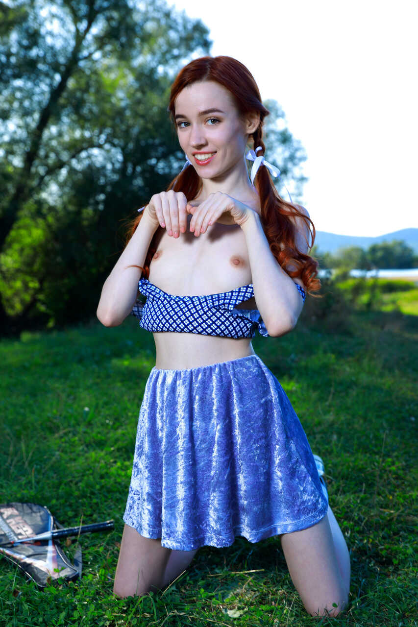 Redheaded teen with small tits Sherice shows off her tight muff in the park