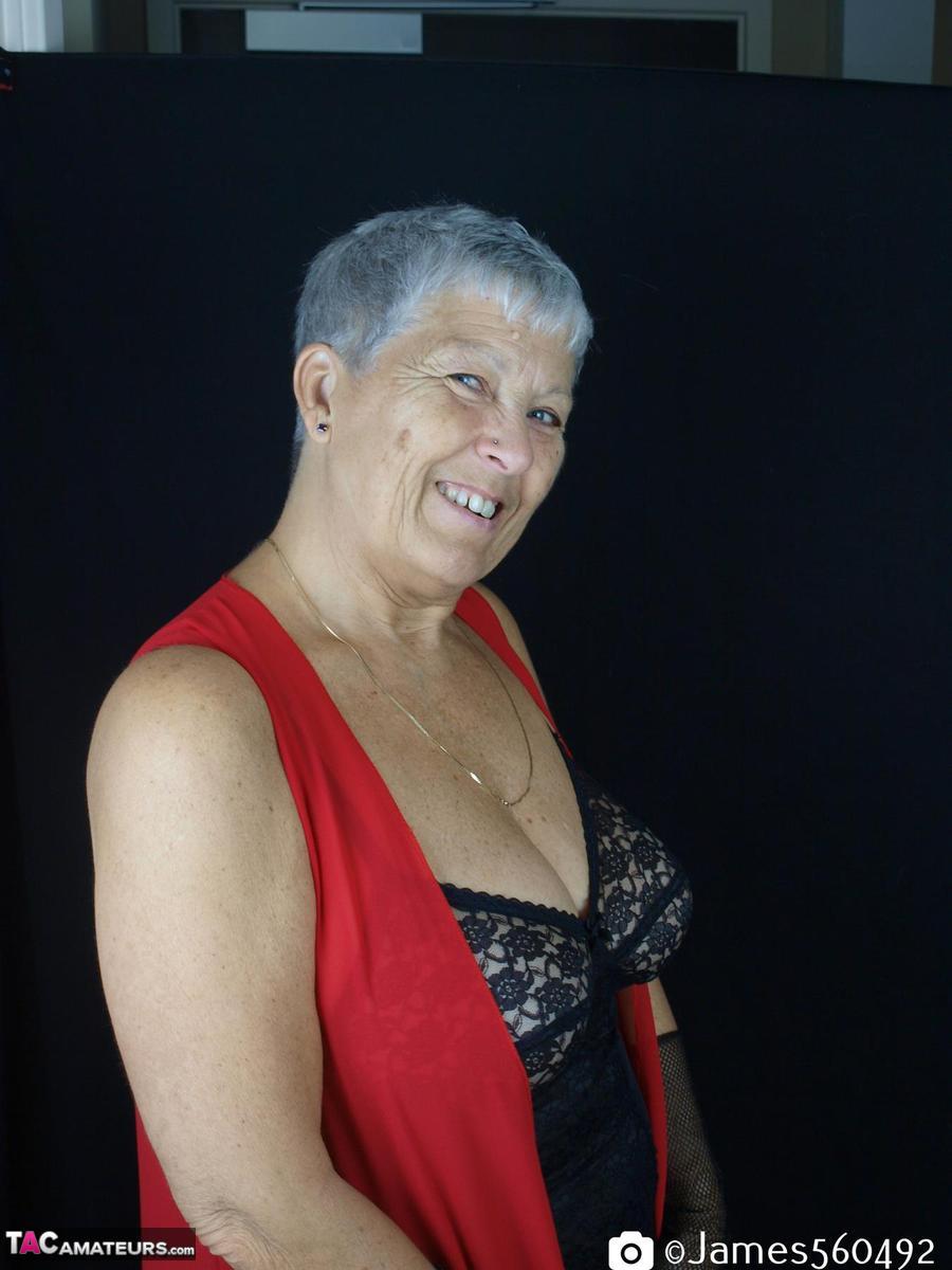 Silver Haired Woman Savana Models Lingerie And Tan Nylons While Wearing Gloves