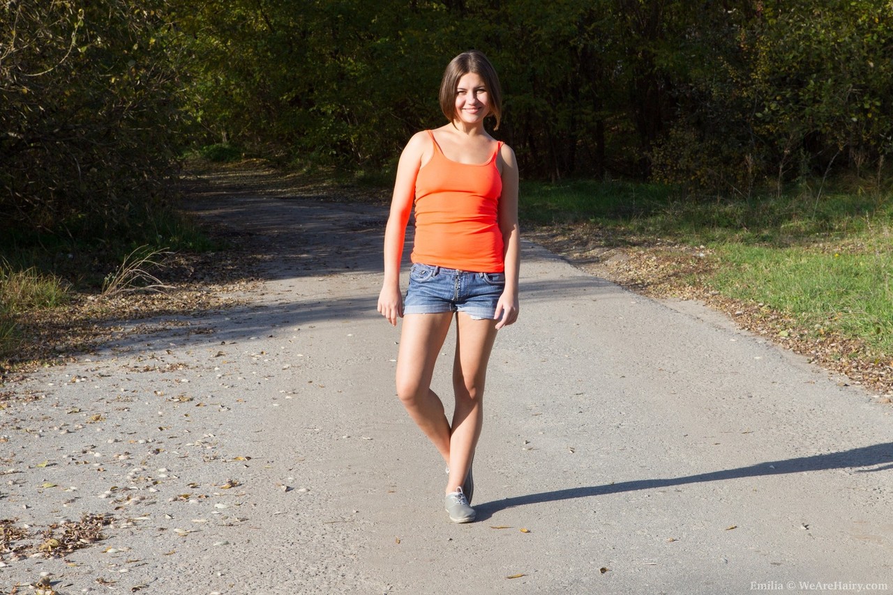 Cute Emilia Doffs Shorts Outdoors To Reveal Hairy Pussy Lounging In Grass