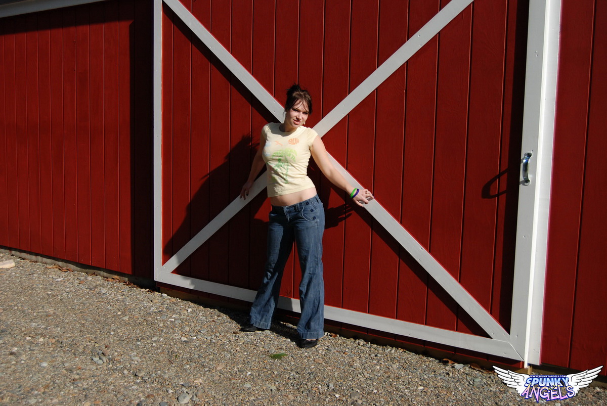 Young Amateur Emily Love Pulls Down Jeans In Front Of Sliding Barn Door