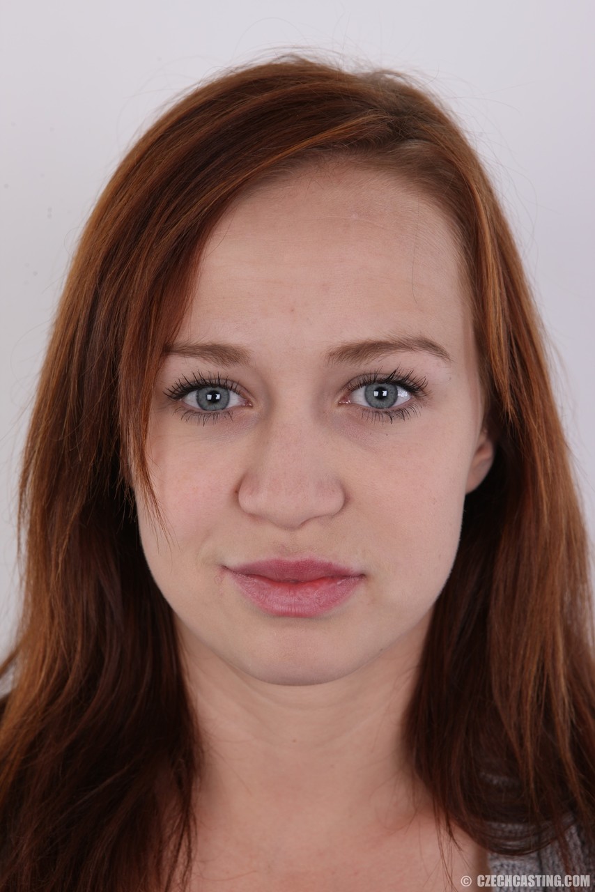 Natural Redhead Dominika Models Clothed Then Stands Totally Naked