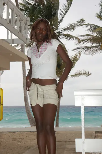 Slim Ebony Redhead Undresses and Poses Nude on the Beach
