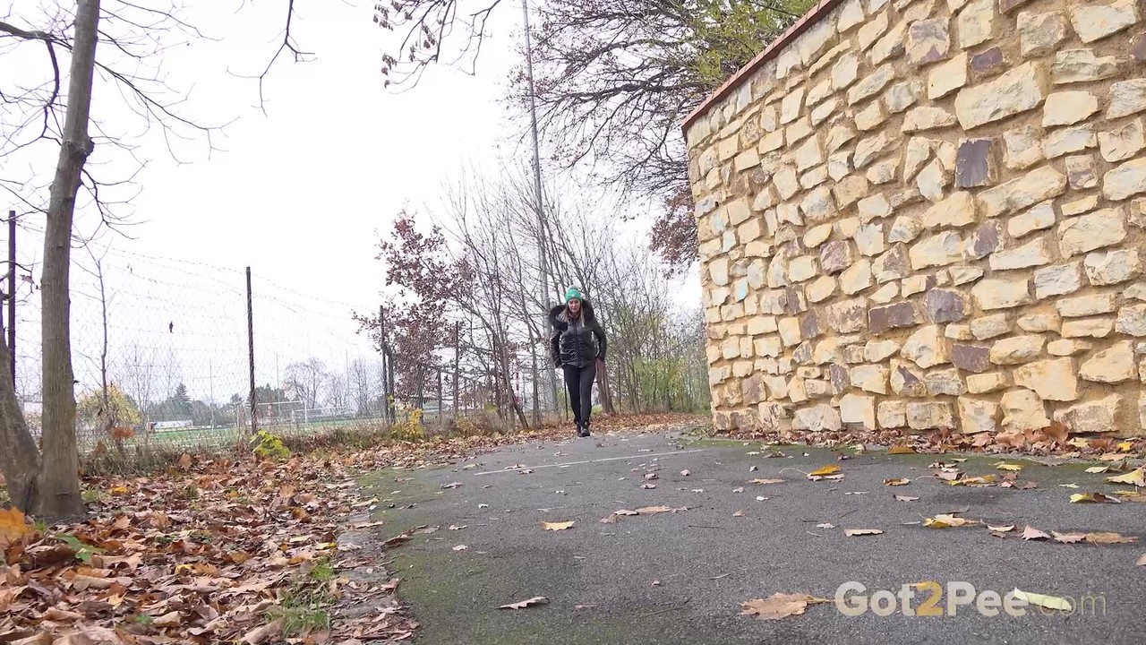 Dark-Haired Girl Naomi Benet Pees On Pavement During Fall Day