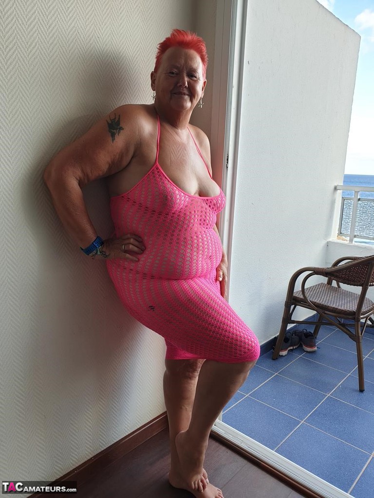 Fat Nan With Short Red Hair Finger Spreads Pussy On Oceanside Balcony