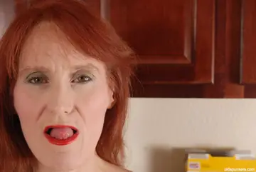 Redhead Granny Fingers Her Shaved Pussy